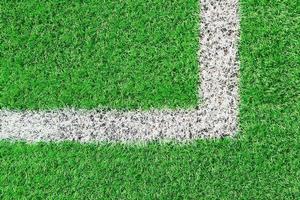 Green grass on sport field with white line photo