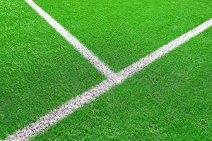 Green grass on sport field with white line photo