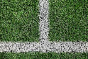 Green grass on sport field with white line photo