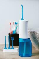 Portable oral irrigator kit in bathroom, waterpik for family use photo