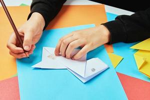 Boy making paper dog origami photo