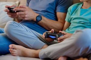 Boy play video game with his father photo