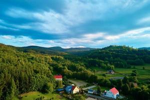 Aerial view of countryside area with village and mountains photo