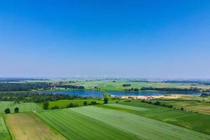 Windmill turbines in green field, Wind energy concept photo