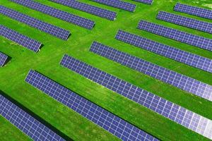 Solar panels in green field, aerial view photo