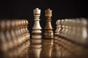 Chess on a dark background. A puzzle game with tricky combinations that requires planning and thinking. photo