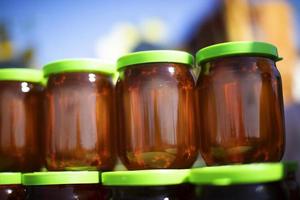 Glass jars filled with honey. Honey trade fair. photo