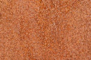 Closeup macro view of flecked old rusty metal surface yellow and orange color photo