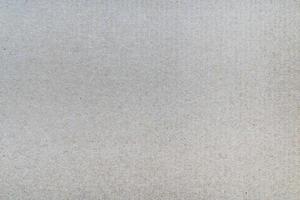 Surface sheet of recycled cardboard. Close-up abstract gray carton texture photo