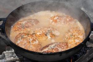 Delicious wild red salmon fish cutlet with gravy fried in griddle roast on coals photo