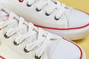 Casual sneakers on yellow background, creative minimalism photo