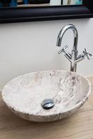 Bathroom interior with marble sink and faucet photo