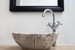 Bathroom interior with marble sink and faucet photo