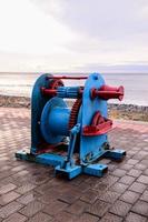 Industrial metal winch on the coast photo