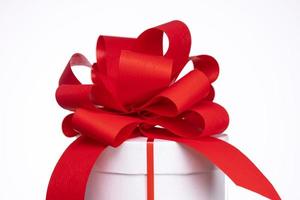 A gift box with a red bow photo