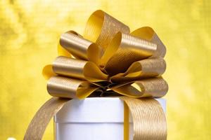 A gift box with a golden bow photo