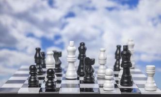 A game of chess with passing clouds behind photo