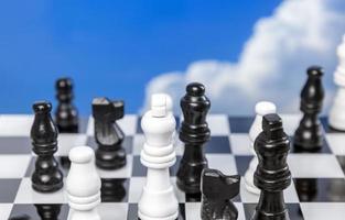 A game of chess with passing clouds behind photo