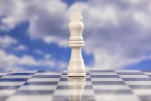 A game of chess with passing clouds behind photo