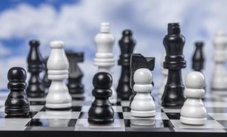 A game of chess with passing clouds behind photo