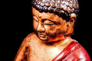 Buddha statue on dark background photo