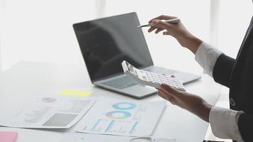 Financial analysts analyze business financial reports on a digital tablet planning investment project during a discussion at a meeting of corporate showing the results of their successful teamwork. video