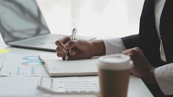 Financial analysts analyze business financial reports on a digital tablet planning investment project during a discussion at a meeting of corporate showing the results of their successful teamwork. video