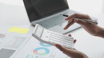 Financial analysts analyze business financial reports on a digital tablet planning investment project during a discussion at a meeting of corporate showing the results of their successful teamwork. video