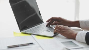 Financial analysts analyze business financial reports on a digital tablet planning investment project during a discussion at a meeting of corporate showing the results of their successful teamwork. video