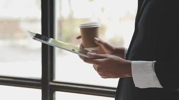 Financial analysts analyze business financial reports on a digital tablet planning investment project during a discussion at a meeting of corporate showing the results of their successful teamwork. video