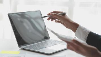 Financial analysts analyze business financial reports on a digital tablet planning investment project during a discussion at a meeting of corporate showing the results of their successful teamwork. video