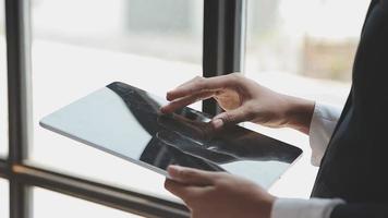 Financial analysts analyze business financial reports on a digital tablet planning investment project during a discussion at a meeting of corporate showing the results of their successful teamwork. video