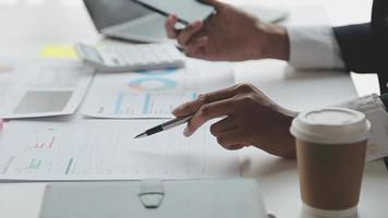 Financial analysts analyze business financial reports on a digital tablet planning investment project during a discussion at a meeting of corporate showing the results of their successful teamwork. video