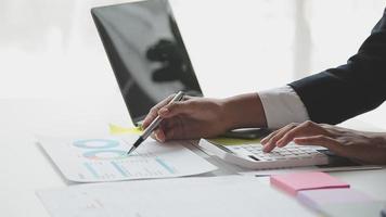 Financial analysts analyze business financial reports on a digital tablet planning investment project during a discussion at a meeting of corporate showing the results of their successful teamwork. video