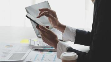 Financial analysts analyze business financial reports on a digital tablet planning investment project during a discussion at a meeting of corporate showing the results of their successful teamwork. video