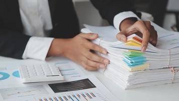 Financial analysts analyze business financial reports on a digital tablet planning investment project during a discussion at a meeting of corporate showing the results of their successful teamwork. video