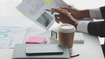 Financial analysts analyze business financial reports on a digital tablet planning investment project during a discussion at a meeting of corporate showing the results of their successful teamwork. video