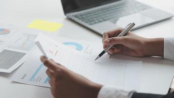 Financial analysts analyze business financial reports on a digital tablet planning investment project during a discussion at a meeting of corporate showing the results of their successful teamwork. video
