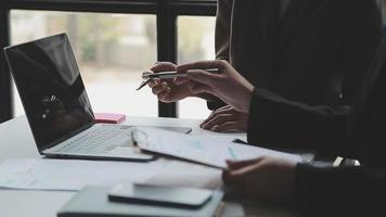 Financial analysts analyze business financial reports on a digital tablet planning investment project during a discussion at a meeting of corporate showing the results of their successful teamwork. video
