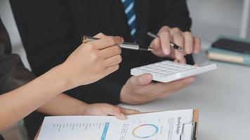 Financial analysts analyze business financial reports on a digital tablet planning investment project during a discussion at a meeting of corporate showing the results of their successful teamwork. video