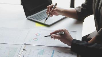 Financial analysts analyze business financial reports on a digital tablet planning investment project during a discussion at a meeting of corporate showing the results of their successful teamwork. video