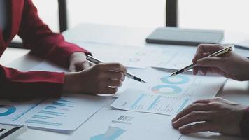 Financial analysts analyze business financial reports on a digital tablet planning investment project during a discussion at a meeting of corporate showing the results of their successful teamwork. video