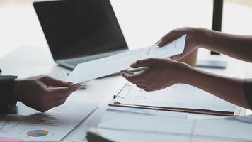 Financial analysts analyze business financial reports on a digital tablet planning investment project during a discussion at a meeting of corporate showing the results of their successful teamwork. video