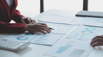 Financial analysts analyze business financial reports on a digital tablet planning investment project during a discussion at a meeting of corporate showing the results of their successful teamwork. video