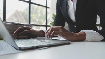 Financial analysts analyze business financial reports on a digital tablet planning investment project during a discussion at a meeting of corporate showing the results of their successful teamwork. video