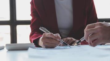 Financial analysts analyze business financial reports on a digital tablet planning investment project during a discussion at a meeting of corporate showing the results of their successful teamwork. video
