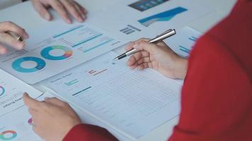Financial analysts analyze business financial reports on a digital tablet planning investment project during a discussion at a meeting of corporate showing the results of their successful teamwork. video
