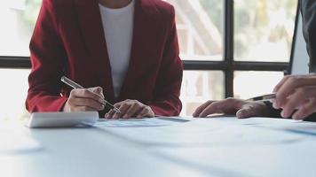 Financial analysts analyze business financial reports on a digital tablet planning investment project during a discussion at a meeting of corporate showing the results of their successful teamwork. video