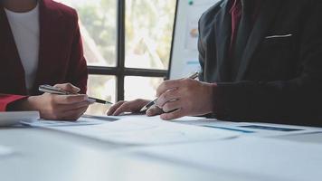 Financial analysts analyze business financial reports on a digital tablet planning investment project during a discussion at a meeting of corporate showing the results of their successful teamwork. video