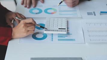 Financial analysts analyze business financial reports on a digital tablet planning investment project during a discussion at a meeting of corporate showing the results of their successful teamwork. video